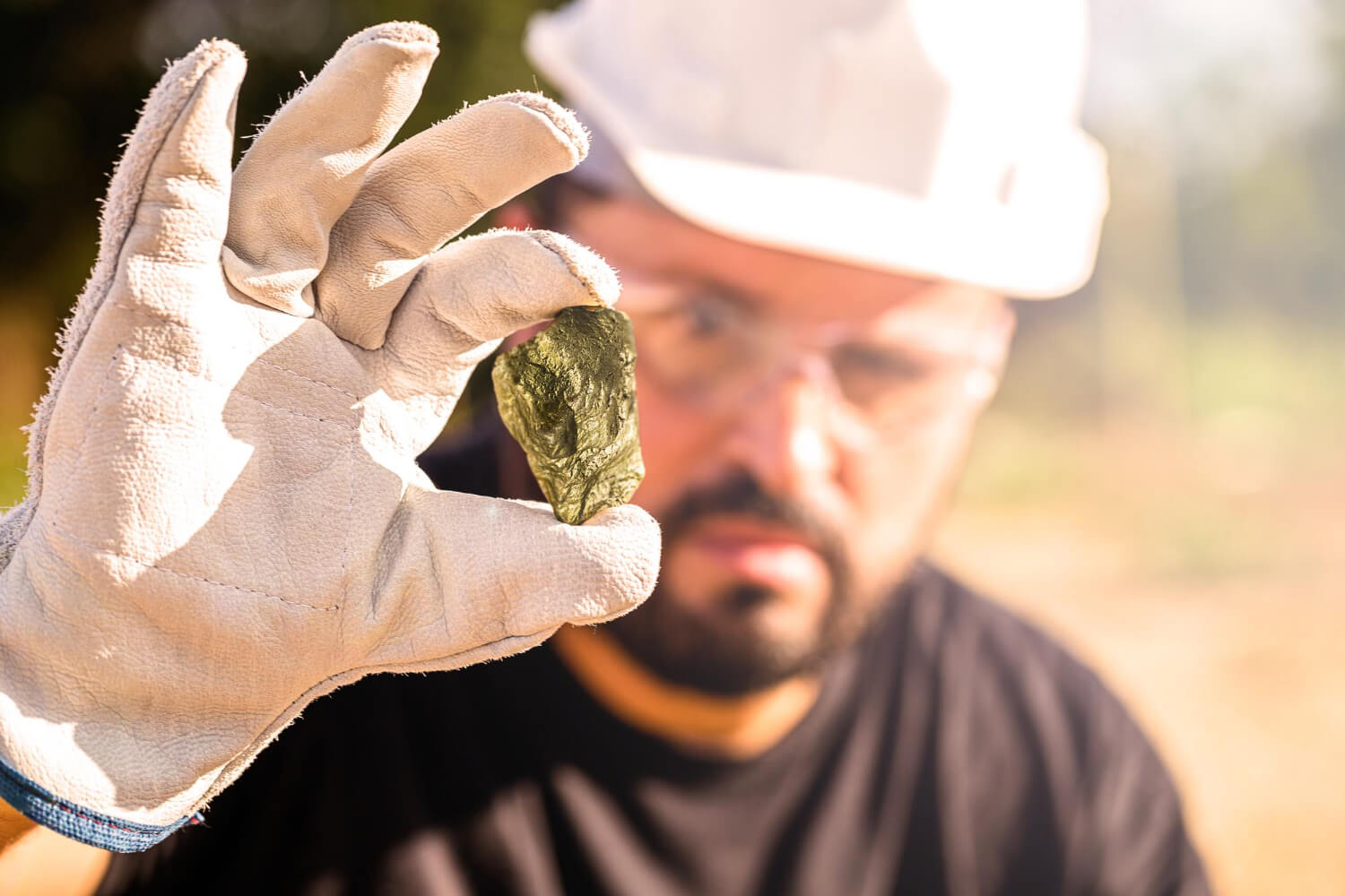 Miner Holding Gold Nugget Point Focus Gemstone Mineral Exploration